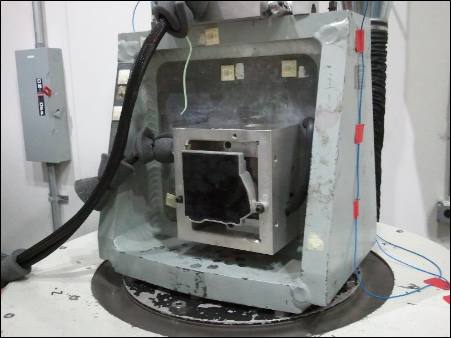 Module fixtured on a vibration table during validation testing