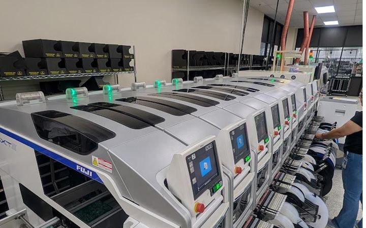 Operator loading component feeders on the Fuji NXT III placement line at Soaris
