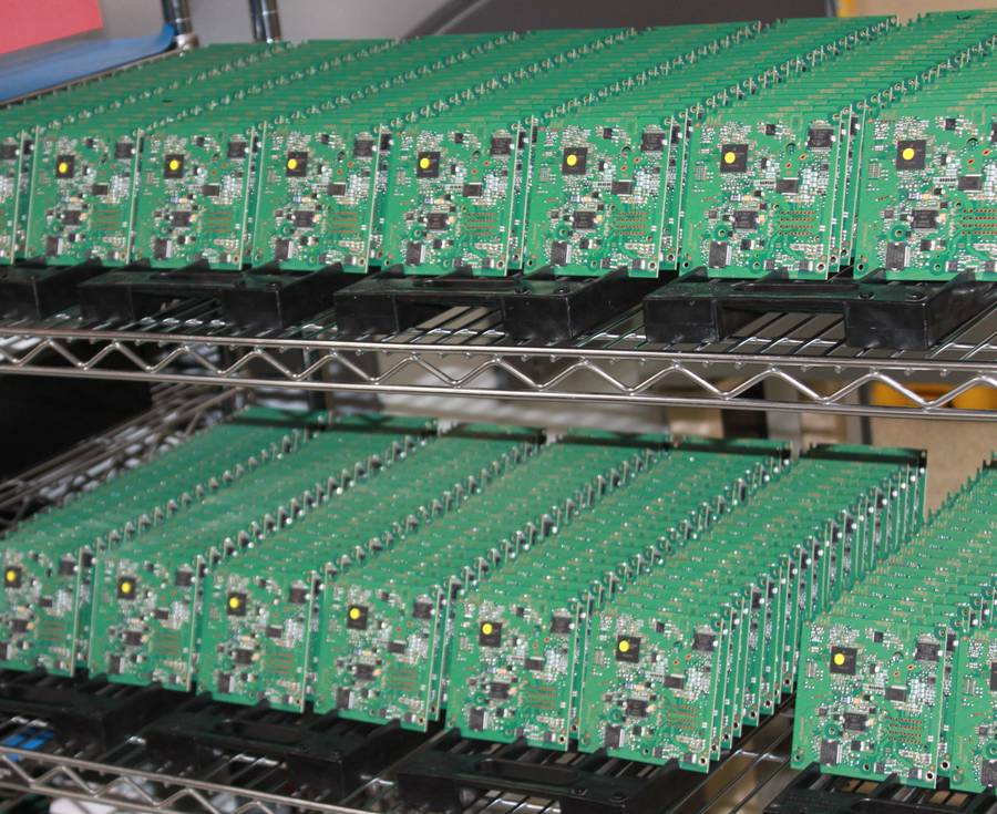 Populated printed circuit boards racked after placement at Soaris
